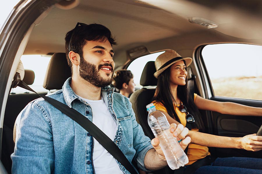 Personal Insurance - Young Parents and Son Take a Drive in Their Car, Smiling, Dad Having a Bottle of Water